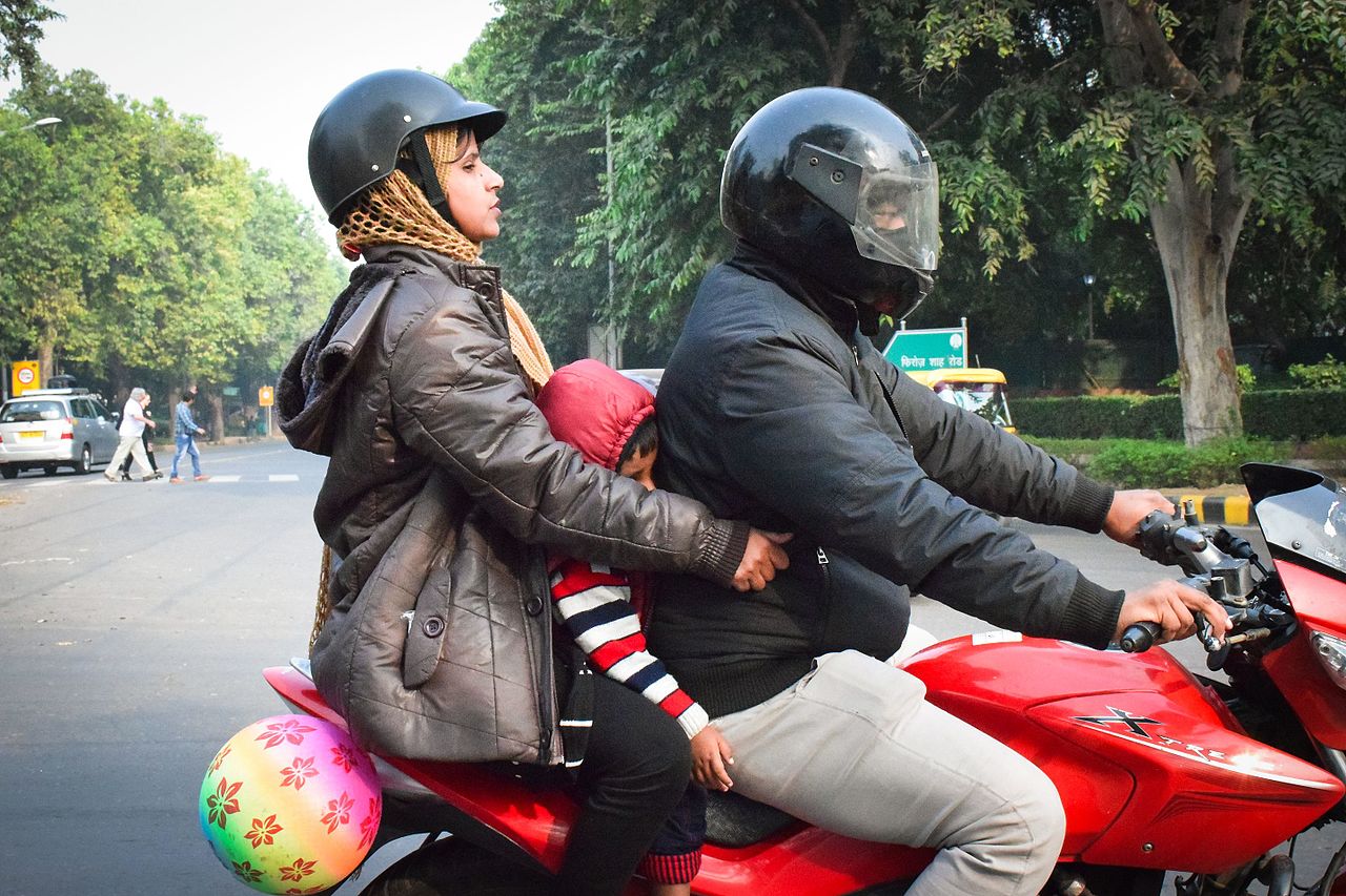 Two adults and a Child on a Motorcycle